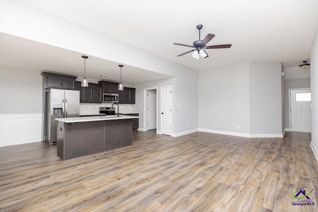 136 Sourwood Ln, Centerville, GA 31093 - kitchen with appliances with stainless steel finishes, a sink, light countertops, a center island with sink, and open floor plan