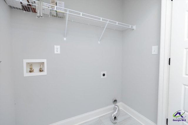 136 Sourwood Ln, Centerville, GA 31093 - laundry area featuring hookup for an electric dryer, hookup for a washing machine, and baseboards