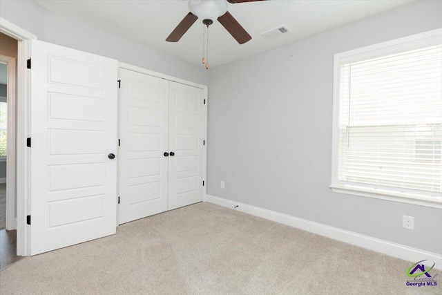 136 Sourwood Ln, Centerville, GA 31093 - unfurnished bedroom with light colored carpet, a closet, baseboards, and a ceiling fan