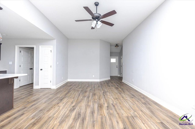 136 Sourwood Ln, Centerville, GA 31093 - unfurnished living room featuring ceiling fan, wood finished floors, and baseboards