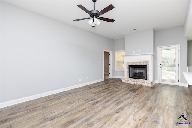 136 Sourwood Ln, Centerville, GA 31093 - unfurnished living room with wood finished floors, a fireplace, baseboards, and a ceiling fan