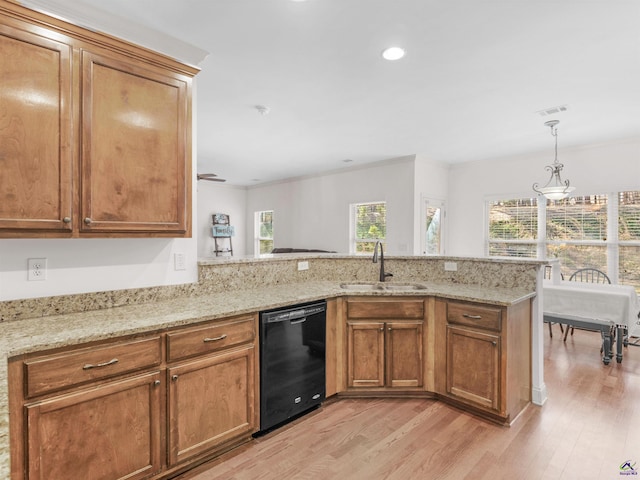 427 Oscar Ct, Mcdonough, GA 30252 - kitchen featuring black dishwasher, a sink, light wood-style floors, brown cabinets, and a peninsula
