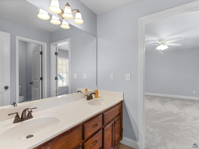 427 Oscar Ct, Mcdonough, GA 30252 - full bath with toilet, ceiling fan, double vanity, baseboards, and a chandelier