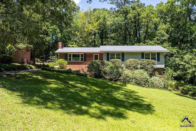 3015 Clairmont Ave, Macon, GA 31204 - view of front facade featuring a front lawn, a chimney, and brick siding