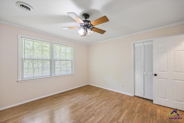3015 Clairmont Ave, Macon, GA 31204 - unfurnished bedroom with light wood-type flooring, baseboards, ornamental molding, a closet, and a ceiling fan