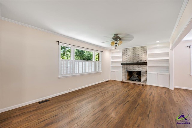 3015 Clairmont Ave, Macon, GA 31204 - unfurnished living room featuring ornamental molding, ceiling fan, wood finished floors, a brick fireplace, and baseboards
