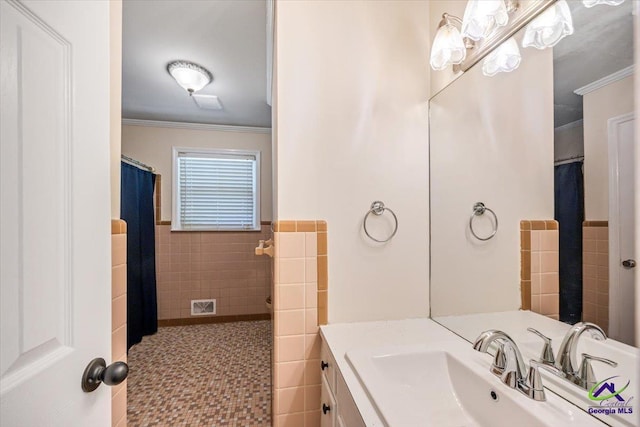 3015 Clairmont Ave, Macon, GA 31204 - full bath with tile walls, ornamental molding, vanity, wainscoting, and tile patterned floors