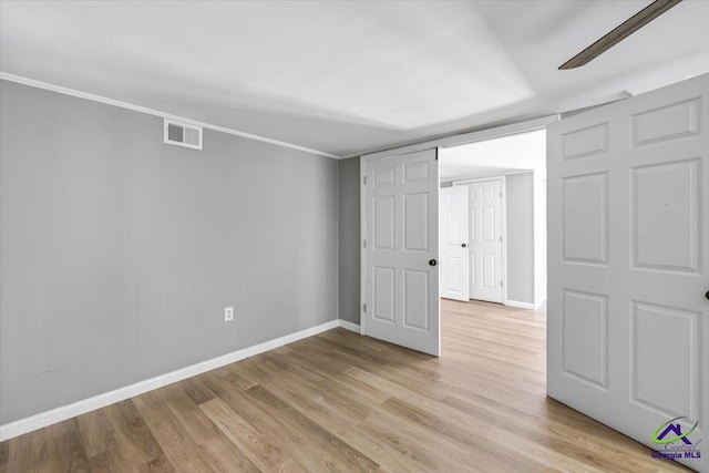 3015 Clairmont Ave, Macon, GA 31204 - unfurnished bedroom with light wood-type flooring, baseboards, and ornamental molding