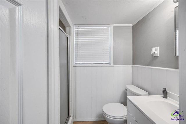 3015 Clairmont Ave, Macon, GA 31204 - bathroom with a shower stall, vanity, toilet, and a wainscoted wall