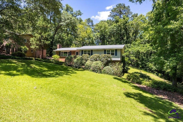 3015 Clairmont Ave, Macon, GA 31204 - view of front facade with a front lawn, a chimney, and brick siding