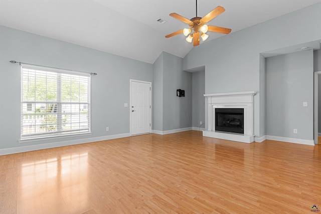 210 Vining Way, Byron, GA 31008 - unfurnished living room with a ceiling fan, light wood-style floors, a fireplace with raised hearth, high vaulted ceiling, and baseboards