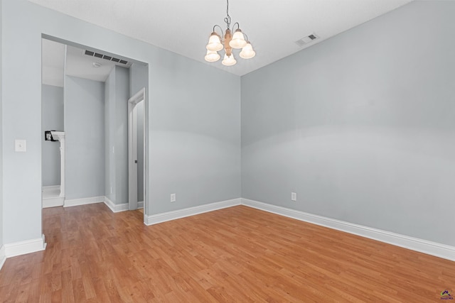 210 Vining Way, Byron, GA 31008 - spare room featuring a chandelier, light wood-style flooring, and baseboards
