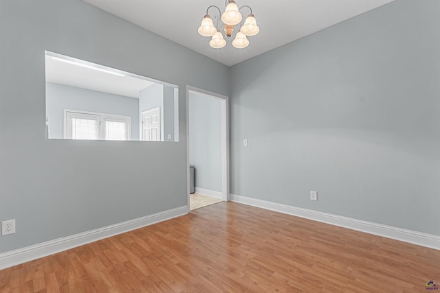 210 Vining Way, Byron, GA 31008 - empty room with a chandelier, wood finished floors, and baseboards