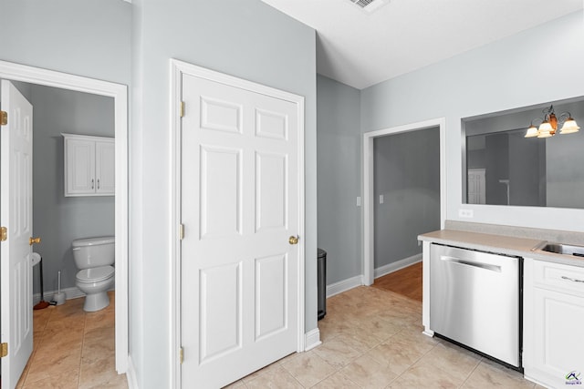 210 Vining Way, Byron, GA 31008 - kitchen with stainless steel dishwasher, light countertops, a chandelier, white cabinetry, and baseboards