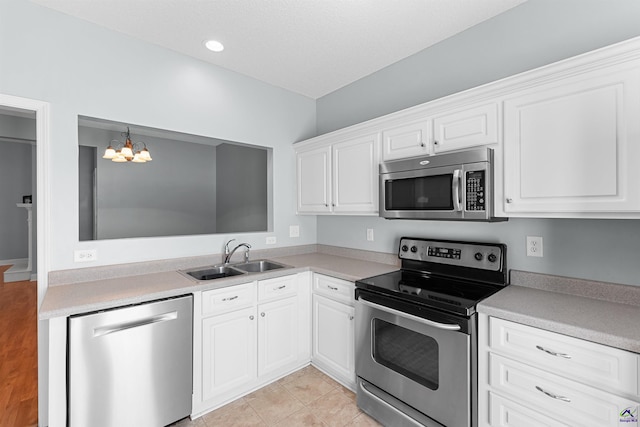 210 Vining Way, Byron, GA 31008 - kitchen featuring stainless steel appliances, a sink, a chandelier, white cabinets, and light countertops