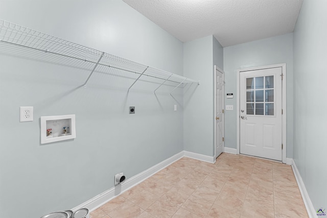 210 Vining Way, Byron, GA 31008 - laundry area featuring electric dryer hookup, hookup for a washing machine, a textured ceiling, and baseboards