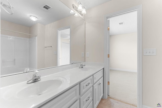 210 Vining Way, Byron, GA 31008 - bathroom with double vanity, tile patterned flooring, baseboards, and a shower