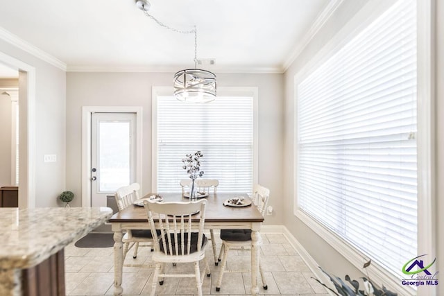 215 Wilson Creek Bnd, Bonaire, GA 31005 - dining space featuring light tile patterned flooring, ornamental molding, a chandelier, and baseboards