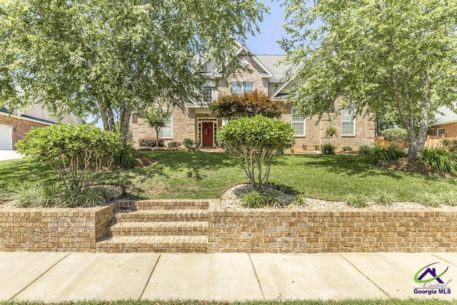 215 Wilson Creek Bnd, Bonaire, GA 31005 - obstructed view of property with a front lawn and brick siding