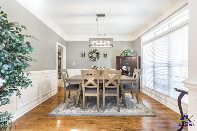 215 Wilson Creek Bnd, Bonaire, GA 31005 - dining space featuring plenty of natural light, crown molding, wainscoting, and wood finished floors