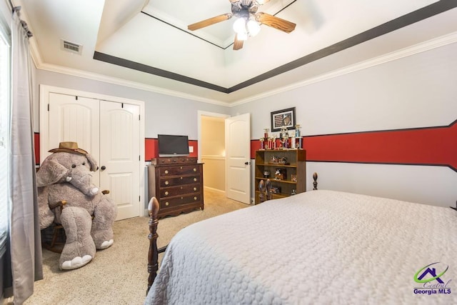 215 Wilson Creek Bnd, Bonaire, GA 31005 - carpeted bedroom featuring a tray ceiling, ornamental molding, a closet, and a ceiling fan