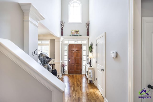 215 Wilson Creek Bnd, Bonaire, GA 31005 - entryway featuring decorative columns, wood finished floors, and a high ceiling