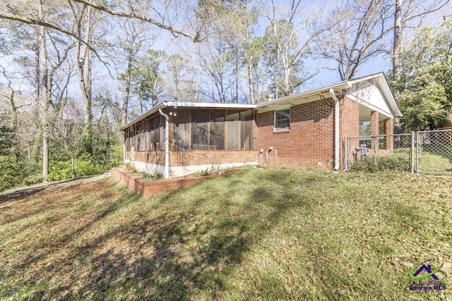 1035 S Pine Knoll Dr, Macon, GA 31204 - view of side of property featuring a sunroom, a gate, and brick siding