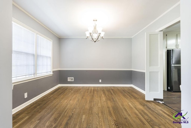 1035 S Pine Knoll Dr, Macon, GA 31204 - empty room featuring a chandelier, dark wood-style floors, crown molding, and baseboards