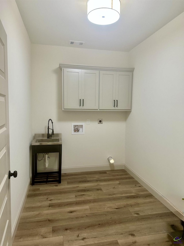 86 Camden Way, Hawkinsville, GA 31036 - laundry room with cabinet space, washer hookup, hookup for an electric dryer, light wood finished floors, and baseboards