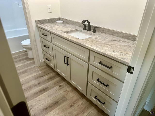 86 Camden Way, Hawkinsville, GA 31036 - full bath with toilet, vanity, and wood finished floors