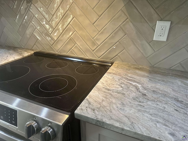 86 Camden Way, Hawkinsville, GA 31036 - kitchen view of stainless steel range with electric stovetop and light stone countertops