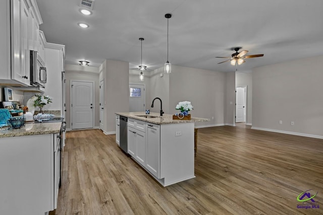 3054 Cellar Ln, Perry, GA 31069 - kitchen featuring a sink, stainless steel appliances, baseboards, ceiling fan, and white cabinetry