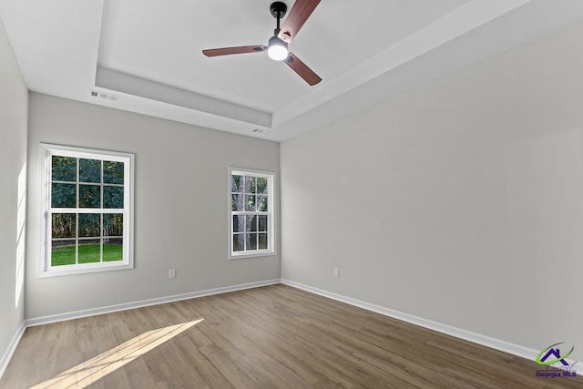 3054 Cellar Ln, Perry, GA 31069 - empty room with a raised ceiling, wood finished floors, ceiling fan, and baseboards