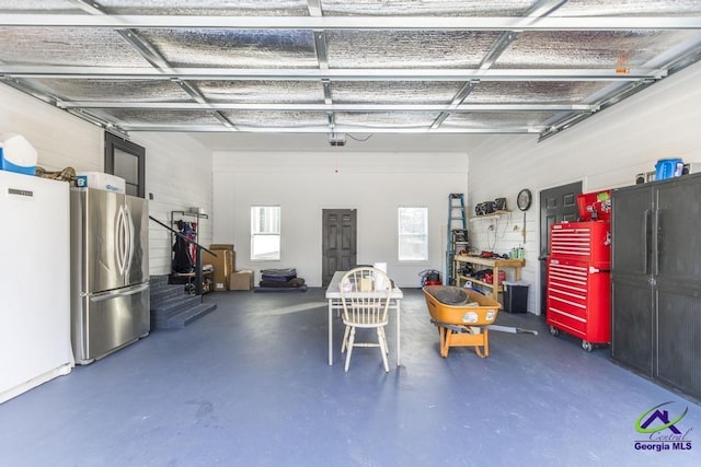 171 N Valhalla Dr, Cordele, GA 31015 - garage featuring freestanding refrigerator and a garage door opener