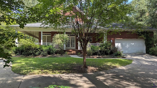107 Whitney Ct, Warner Robins, GA 31088 - view of front of house with a porch, brick siding, driveway, and an attached garage