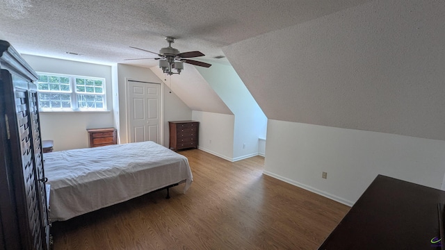 107 Whitney Ct, Warner Robins, GA 31088 - bedroom with a textured ceiling, wood finished floors, lofted ceiling, baseboards, and a ceiling fan