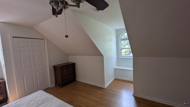 107 Whitney Ct, Warner Robins, GA 31088 - unfurnished bedroom with wood finished floors, vaulted ceiling, a textured ceiling, ceiling fan, and a closet