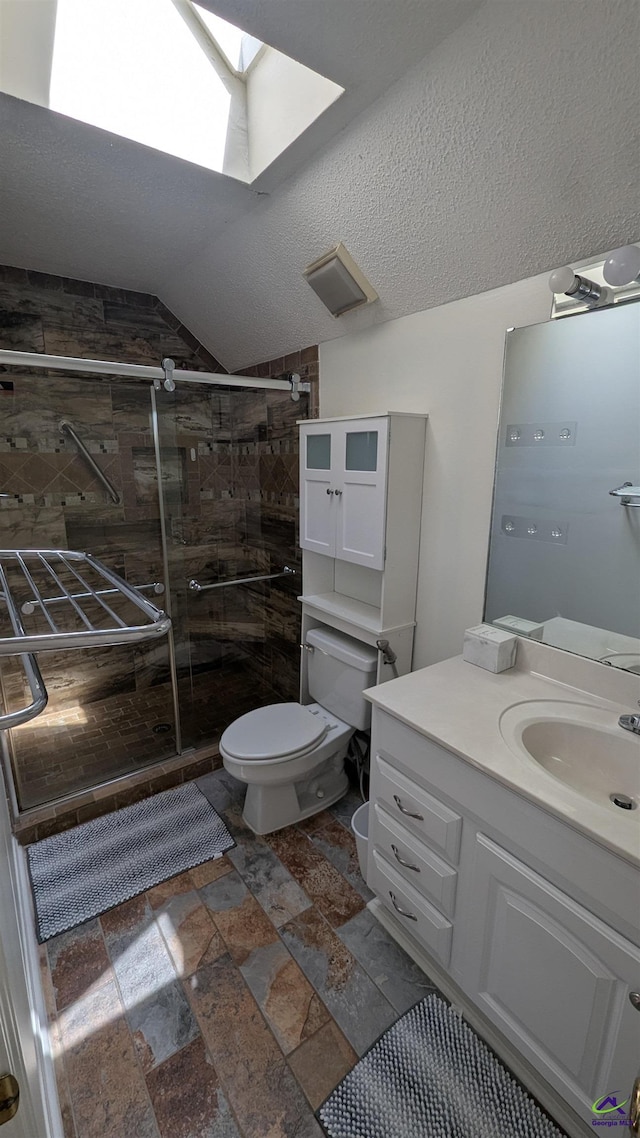 107 Whitney Ct, Warner Robins, GA 31088 - full bath with a stall shower, vanity, a skylight, toilet, and lofted ceiling