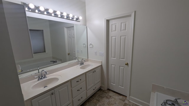 107 Whitney Ct, Warner Robins, GA 31088 - full bathroom featuring double vanity, a garden tub, baseboards, and stone finish flooring