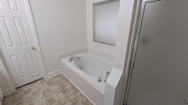 107 Whitney Ct, Warner Robins, GA 31088 - bathroom with a garden tub, stone finish flooring, and a stall shower