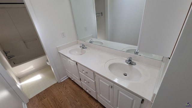 107 Whitney Ct, Warner Robins, GA 31088 - full bath featuring double vanity, wood finished floors,  shower combination, and baseboards