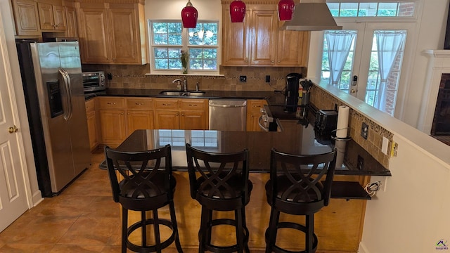 107 Whitney Ct, Warner Robins, GA 31088 - kitchen featuring stainless steel appliances, a sink, tasteful backsplash, light tile patterned floors, and dark countertops