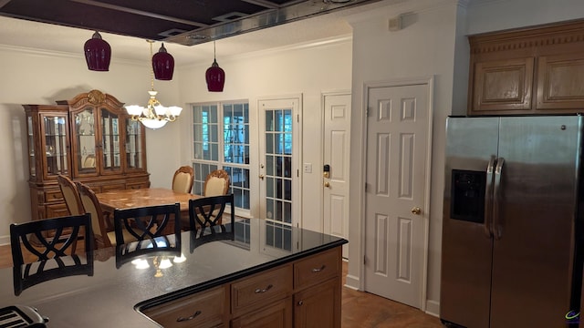 107 Whitney Ct, Warner Robins, GA 31088 - kitchen featuring stainless steel fridge, dark countertops, a chandelier, ornamental molding, and pendant lighting