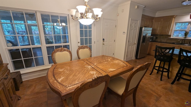 107 Whitney Ct, Warner Robins, GA 31088 - dining area featuring a chandelier, crown molding, and dark tile patterned floors