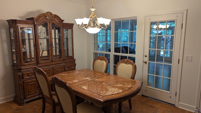 107 Whitney Ct, Warner Robins, GA 31088 - dining area featuring a chandelier, dark tile patterned floors, baseboards, and crown molding