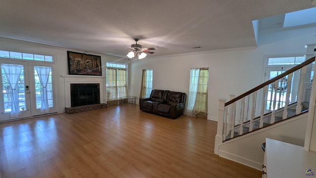 107 Whitney Ct, Warner Robins, GA 31088 - living area featuring wood finished floors, ornamental molding, stairway, a ceiling fan, and a fireplace