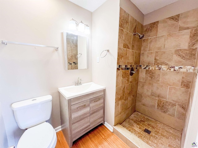 109 Stoneridge Dr, Warner Robins, GA 31088 - bathroom featuring vanity, tiled shower, toilet, and wood finished floors