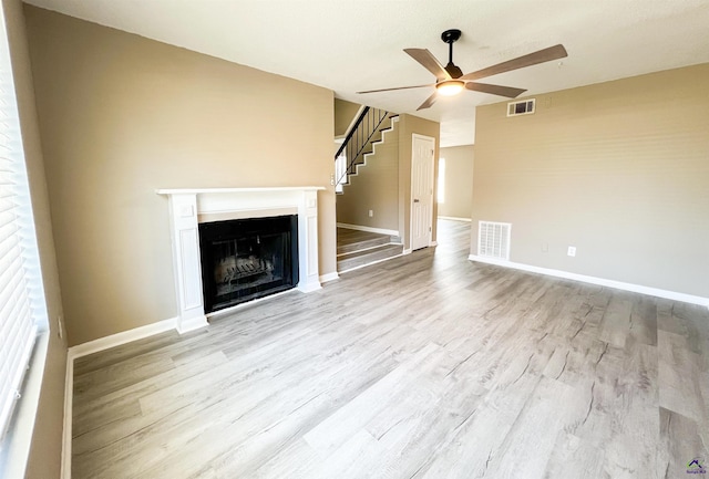 109 Stoneridge Dr, Warner Robins, GA 31088 - unfurnished living room with ceiling fan, wood finished floors, a fireplace, baseboards, and stairs