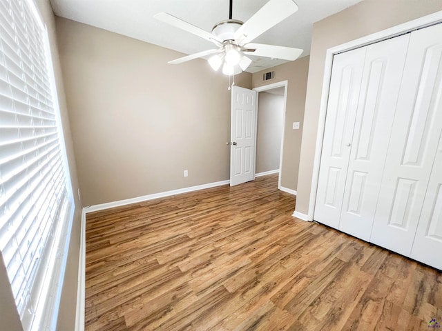 109 Stoneridge Dr, Warner Robins, GA 31088 - unfurnished bedroom featuring multiple windows, light wood finished floors, a closet, and baseboards