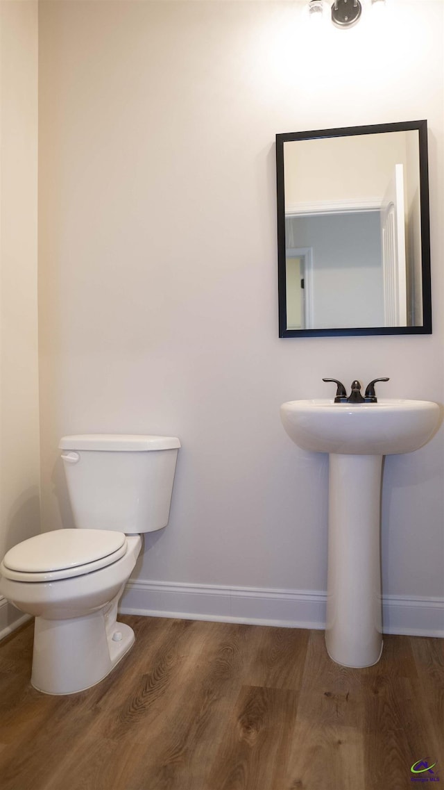 303 Garnet Dr, Bonaire, GA 31005 - bathroom with baseboards, wood finished floors, toilet, and a sink